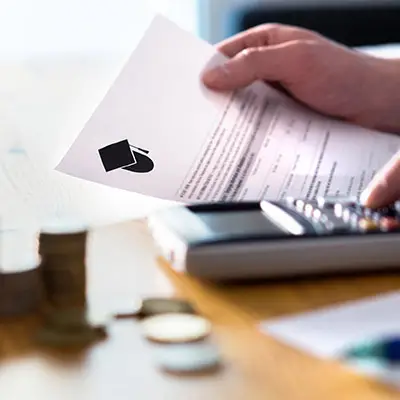 Image of calculator an student loan document